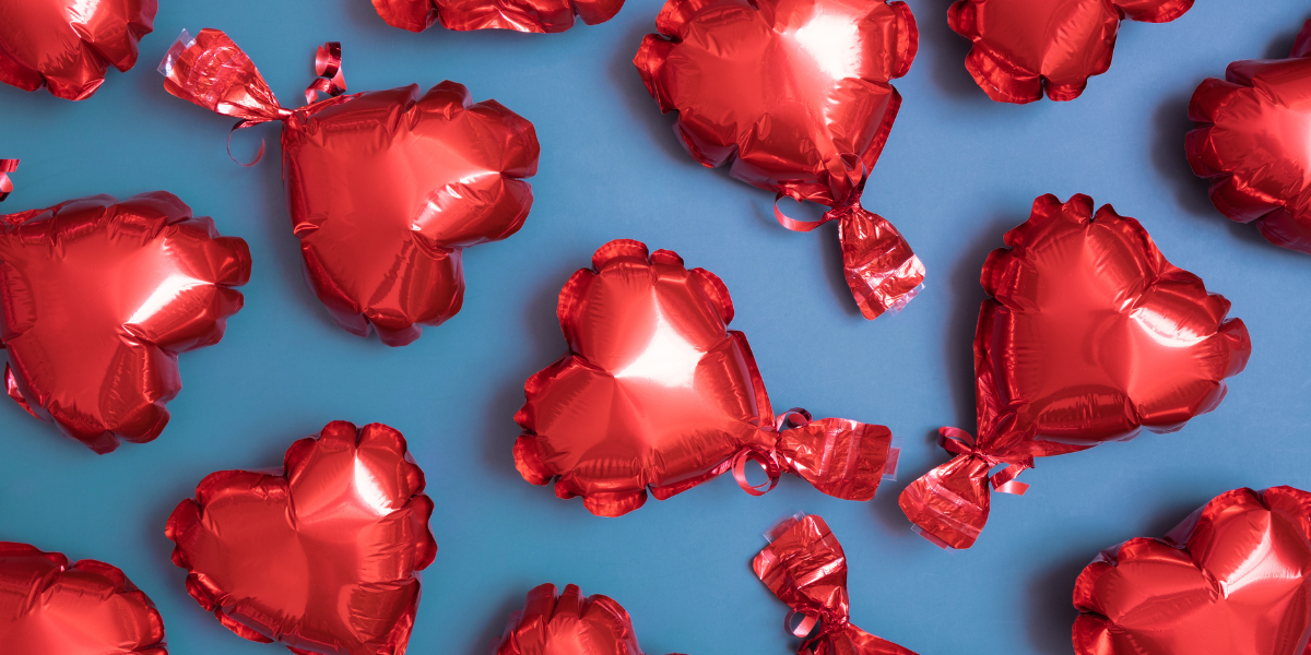 red, heart-shaped balloons on a blue background