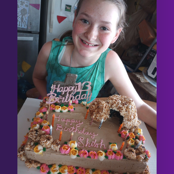 Smiling girl with the birthday cake