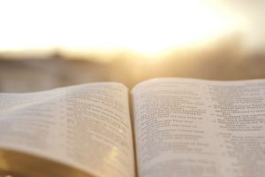 Open Bible with bright sunset in the background