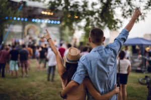 Young couple celebrating at a music festival