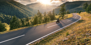 A motorcyclist driving along a mountain road